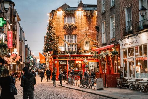 a city street with a christmas tree and people walking at Ha'penny View House in Dublin