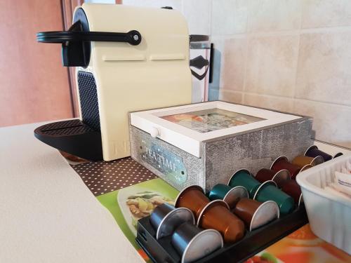 a box full of wine bottles next to a sewing machine at Corte Pomponazza in Mantova