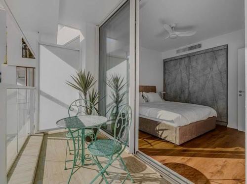 a bedroom with a bed and a table and chairs at Redsearent suite with pool view 2 in Eilat