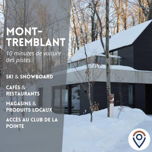a sign in front of a building in the snow at SpaHaus #128 in Lac-Superieur