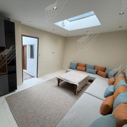 a living room with a couch and a table at Serenity Sea Villa Taghazout Bay Amda in Taghazout