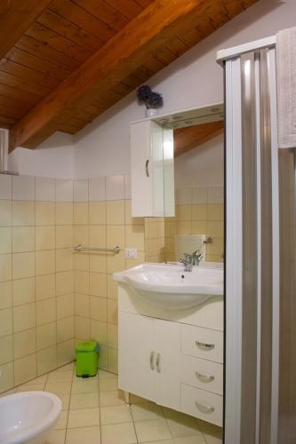 a bathroom with a sink and a toilet at Asaro Camere in Campobello di Licata