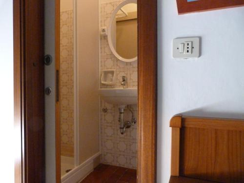 a bathroom with a sink and a mirror at Hotel Bologna in San Benedetto del Tronto