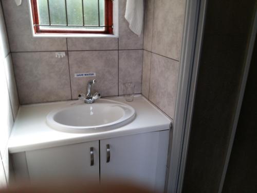 a bathroom with a sink and a window at 110 Bay View in Brenton-on-Sea