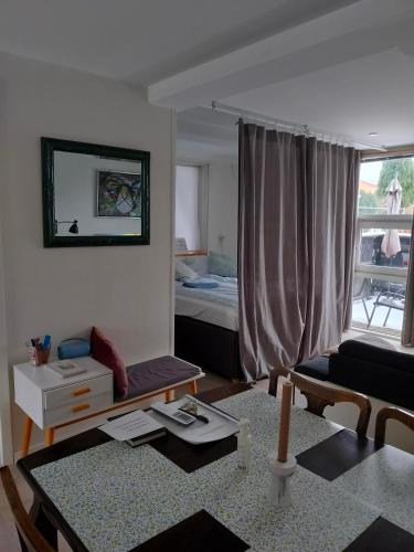 a living room with a couch and a bed at Håstrups Natur Perle in Faaborg