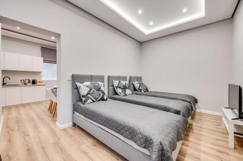 a bedroom with a bed and a kitchen at Central Platinum Apartments 29 in Rybnik