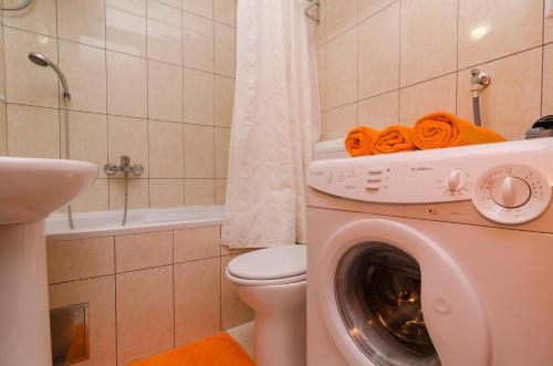 a bathroom with a washing machine and a toilet at Apartment Cavtat Beauty in Cavtat