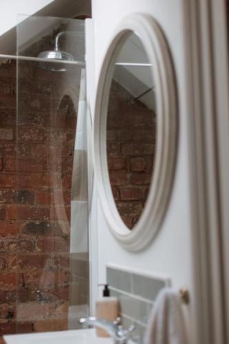 a bathroom with a mirror and a sink at Rosa's Loft in Flamborough