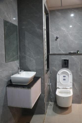 a bathroom with a toilet and a sink at Hotel Lakhdatar in Kota