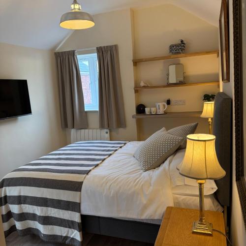 a bedroom with a bed and a table with a lamp at Town Centre - 22 Billet Street in Taunton