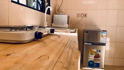 a kitchen with a counter top with a toaster and a stove at Agape hostel in Bagamoyo
