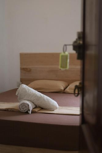 a towel is laying on a bed in a room at Papaya Tree Hostel in Weligama
