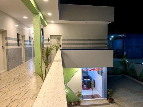 a building with a gas pump on the side of it at Hotel ZB comforts MYSORE in Mysore