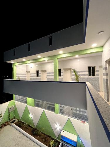 a building with a white and green wall at Hotel ZB comforts MYSORE in Mysore