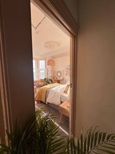 a bedroom with a bed and a large window at Môr Heli Guest House Criccieth in Criccieth