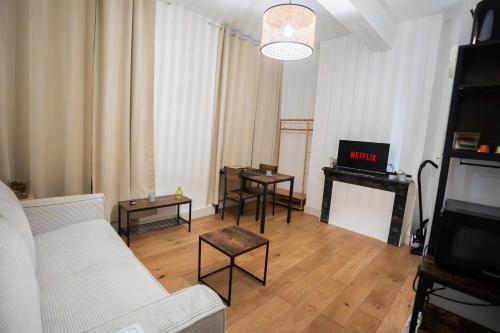 a living room with a white couch and a piano at Charming Elegant Suite - Downtown - AF in Carcassonne