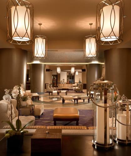 a hotel lobby with couches and tables and lights at Wyndham Grand Orlando Resort Bonnet Creek in Orlando