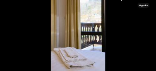 a towel sitting on a table next to a window at Златоград in Zlatograd