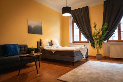 a living room with a bed and a couch at FullHouse - Görlitz - B7 - 3 Bedrooms - SmartTV - Nespresso in Görlitz