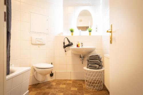 a white bathroom with a sink and a toilet at FullHouse - Görlitz - B7 - 3 Bedrooms - SmartTV - Nespresso in Görlitz