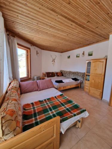 a living room with a couch and a table at The House in Stoykite