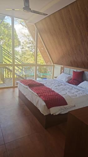 a large bed in a room with a large window at Idukki Nook in Idukki