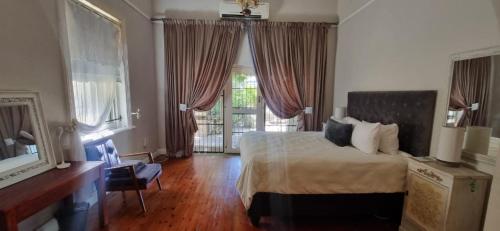 a bedroom with a bed and a large window at 14th on West in Graaff-Reinet