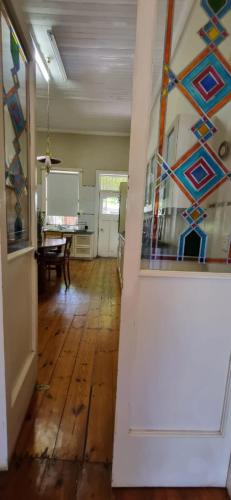 an open hallway with a room with a table at 14th on West in Graaff-Reinet