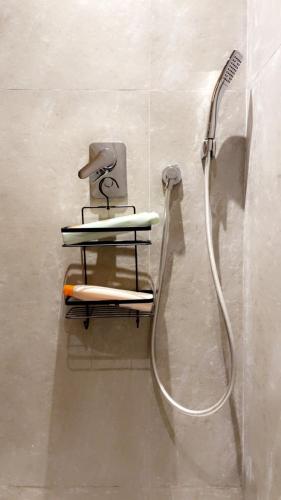a shower in a bathroom with a shower head at Les princesses studio confort-plus charme in Maarif