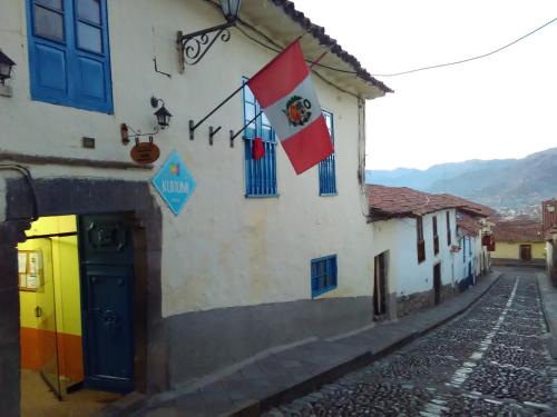 a building with a sign on the side of it at Kurumi Hostel in Cusco