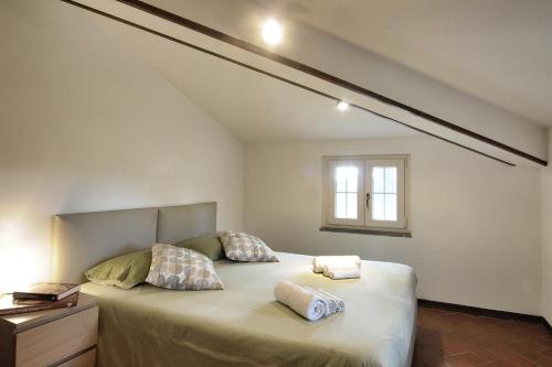 a bedroom with a large bed with two pillows on it at Da Piero e Paola in Arezzo