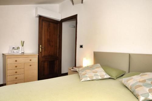 a bedroom with a bed and a wooden door at Da Piero e Paola in Arezzo