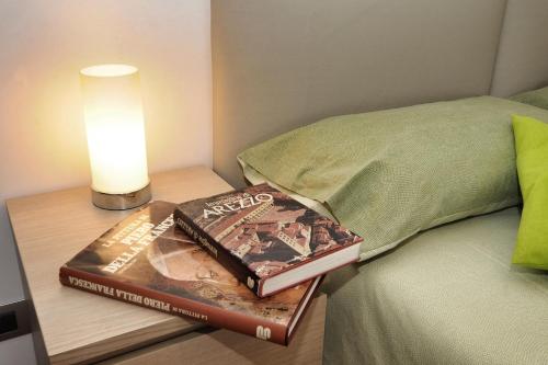 two books sitting on a table next to a bed at Da Piero e Paola in Arezzo