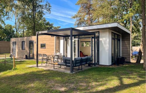 a small cabin with a black roof in a yard at 2 Bedroom Lovely Home In Hellendoorn in Hellendoorn