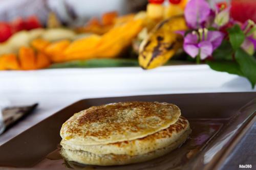a pancake sitting on top of a tray on a table at Luxury Sakina Villa - Beachfront in Dzamandzar