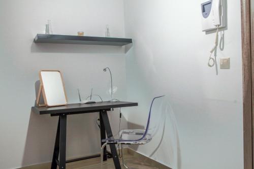 a desk with a laptop and a chair in a room at Lak Peristeri Homes 50m from metro station in Athens