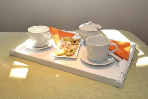 a tray with two cups and a tea set on it at Da Piero e Paola in Arezzo