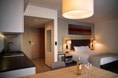 una camera d'albergo con letto e cucina di Bristol Aparthotel a Busko-Zdrój