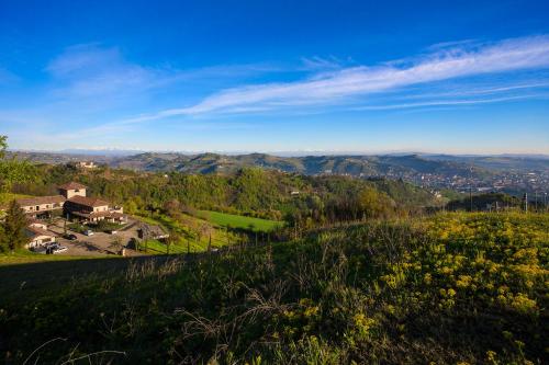 a view of a hill with a house on it at I Tre Poggi Dimora di Charme in Canelli