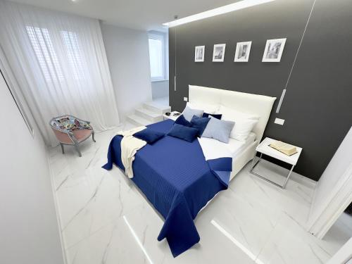 a bedroom with a large bed with blue sheets and pillows at LianHome b&b "Terrazzino" in Lucera