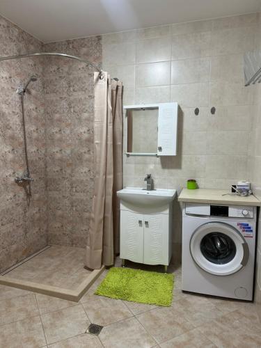 a bathroom with a washing machine and a shower at Tryavna Central Apartments-Relax in Tryavna