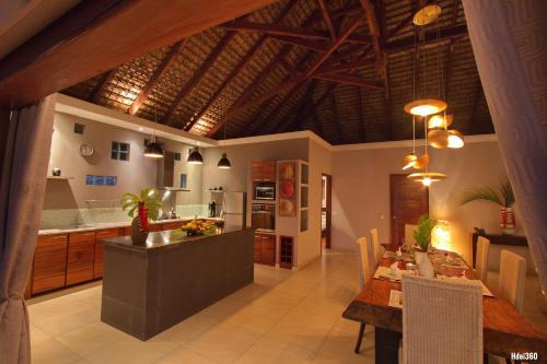 a kitchen and dining room with a table and a dining room at Luxury Sakina Villa - Beachfront in Dzamandzar