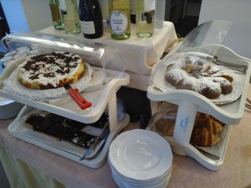 a counter top with two trays of food at Hotel Orchidea in Bardolino