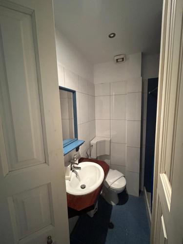 a small bathroom with a sink and a toilet at SEA HOME Accommodation in Loutraki