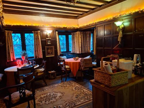 a living room with a table and a dining room at JESMOND House B&B room 1 in Hull