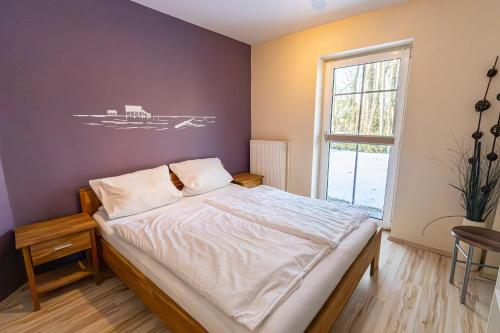 a bedroom with a bed and a window at Appartement Dorfluft in Böhl