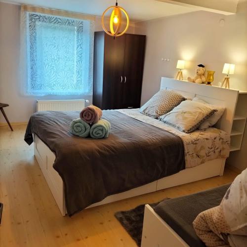 a bedroom with a bed with two towels on it at Gîte Les Copains de Maui in Baerenthal