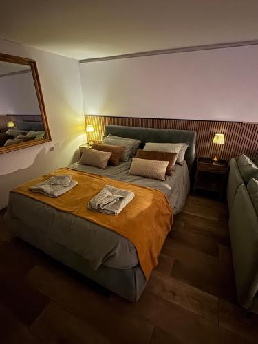 a bedroom with a large bed and a couch at SuitePoolBarcelona in Vilassar de Dalt