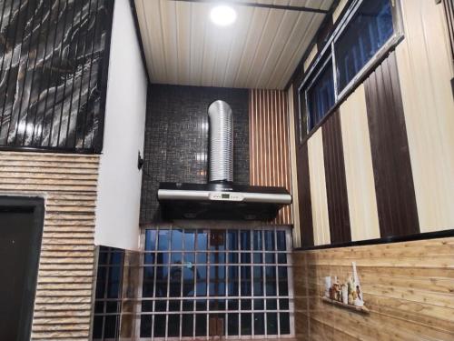 a fireplace in a building with a drinking fountain at Sukoon Villa in Tezpur