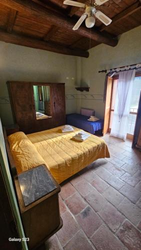 a bedroom with a large bed in a room at Agriturismo La.Ti.Mi.Da. in Cassine